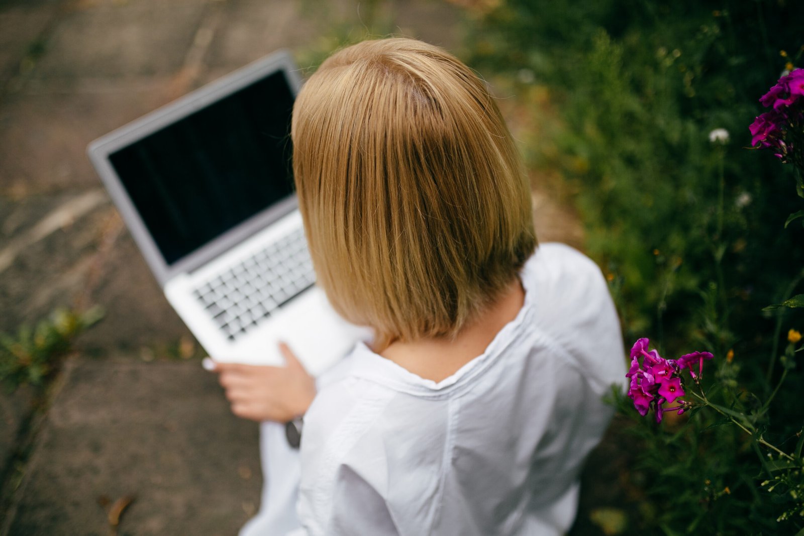 young woman using laptop computer and smart phone. beautiful student girl working on laptop outdoor